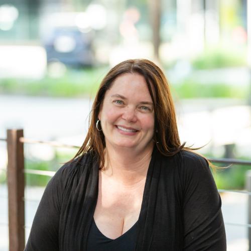 woman sitting at table smiling