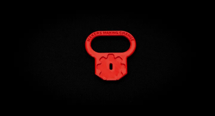 Red key turner with large loop up top for grip, and space for key attachment at bottom